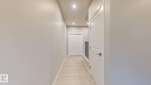 Hallway featuring light-colored walls, recessed lighting, and light wood flooring - 607 31 Avenue, Edmonton, AB - Indoor Photo Showing Other Room