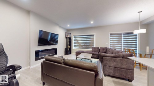 Living area featuring light-colored flooring, recessed lighting, and windows with blinds - 607 31 Avenue, Edmonton, AB - Indoor Photo Showing Living Room With Fireplace