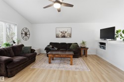 Living area with vaulted ceiling and wood-finish flooring - 