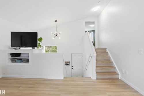 Vaulted ceiling interior featuring light wood-finish flooring - 396 Kananaskis Way, Devon, AB - Indoor Photo Showing Other Room