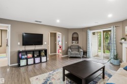 Spacious living area featuring wood-finish flooring, recessed lighting, and a neutral wall palette - 