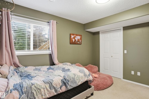 Bedroom featuring a double window with blinds, carpet flooring, a white bi-fold closet, and recessed ceiling lighting - 396 Kananaskis Way, Devon, AB - Indoor Photo Showing Bedroom