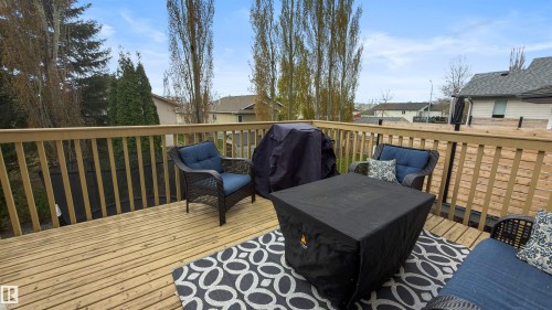 Expansive outdoor deck featuring wood flooring and matching wood railing - 396 Kananaskis Way, Devon, AB - Outdoor With Deck Patio Veranda With Exterior