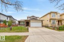 Traditional-style home featuring a two-car garage, brick facade accents, and a large driveway - 8911 84 Avenue, Edmonton, AB  - Outdoor With Facade 
