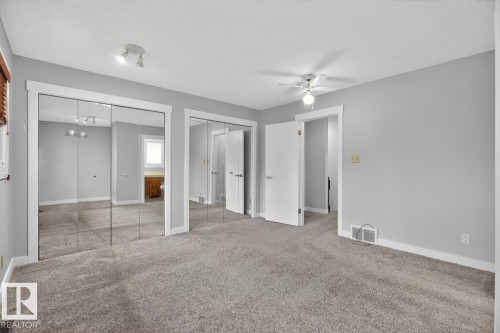 Spacious room featuring light gray walls, gray carpet flooring, white trim, and a ceiling fan - 8911 84 Avenue, Edmonton, AB - Indoor Photo Showing Other Room