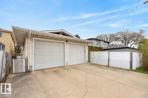 Two-car garage with panel garage doors and stucco exterior - 8911 84 Avenue, Edmonton, AB - Outdoor With Exterior