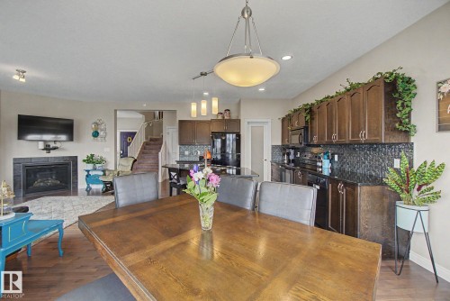 82 Dalquist Bay, Leduc, AB - Indoor Photo Showing Dining Room With Fireplace