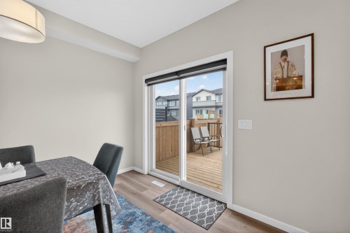 Sliding glass patio door opening to an outdoor wood deck - 332 Juniper Cove, Leduc, AB - Indoor