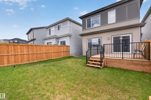 Expansive green lawn with a full wooden privacy fence - 332 Juniper Cove, Leduc, AB - Outdoor With Deck Patio Veranda