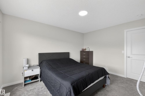 Neutral wall color with a textured ceiling and recessed lighting - 332 Juniper Cove, Leduc, AB - Indoor Photo Showing Bedroom