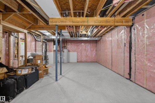 Unfinished basement featuring exposed wood joists and structural beams, insulated walls, and a concrete floor - 332 Juniper Cove, Leduc, AB - Indoor Photo Showing Basement