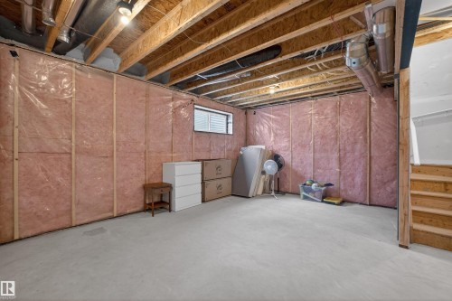 Unfinished basement with exposed ceiling joists and concrete flooring - 332 Juniper Cove, Leduc, AB - Indoor Photo Showing Basement