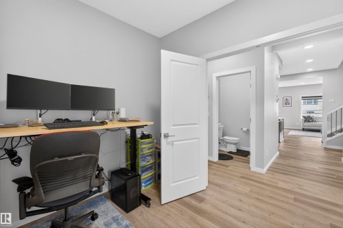 Dedicated workspace featuring a standing desk and light wood-finish flooring - 332 Juniper Cove, Leduc, AB - Indoor Photo Showing Office