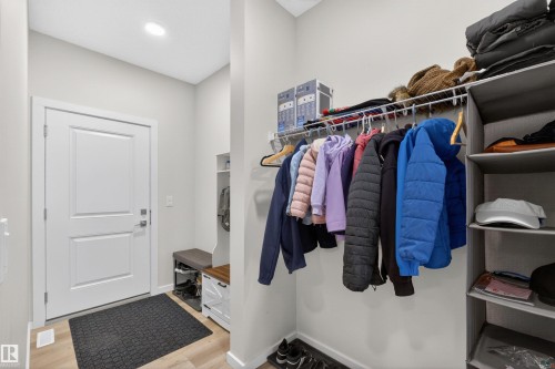 Entryway featuring light wood-finish flooring, a contemporary white door, and recessed ceiling lighting - 332 Juniper Cove, Leduc, AB - Indoor With Storage