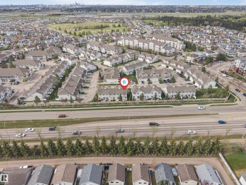 Aerial perspective of a multi-lane roadway bordered by mature evergreen trees - 135 150 Edwards Drive, Edmonton, AB - Outdoor With View