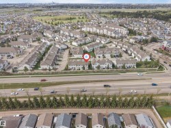 Aerial perspective of a multi-lane roadway bordered by mature evergreen trees - 