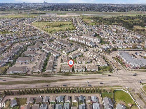 Aerial perspective showcasing a residential community with varied housing types - 135 150 Edwards Drive, Edmonton, AB - Outdoor With View