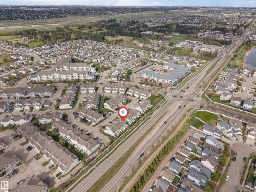 Aerial overview of a residential neighborhood with detached homes, townhomes, and a multi-story apartment building - 135 150 Edwards Drive, Edmonton, AB -  With View