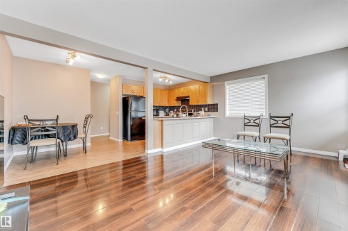 Open-concept living space featuring wood-finish flooring throughout - 135 150 Edwards Drive, Edmonton, AB - Indoor