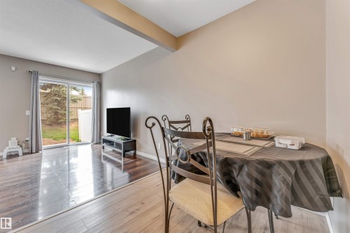 Open-concept living area featuring a sliding glass door providing direct outdoor access - 135 150 Edwards Drive, Edmonton, AB - Indoor