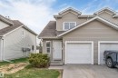 Residential property featuring beige horizontal siding, an attached single-car garage, and a concrete driveway - 135 150 Edwards Drive, Edmonton, AB  - Outdoor 