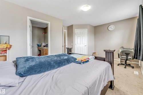 Carpeted bedroom with neutral wall tones and a ceiling-mounted light fixture - 135 150 Edwards Drive, Edmonton, AB - Indoor Photo Showing Bedroom