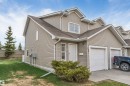 Multi-level exterior with light-toned siding, a peaked roofline, and attached garage - 135 150 Edwards Drive, Edmonton, AB  - Outdoor 