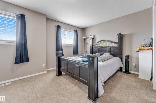 Neutral-toned walls complement the light-colored carpet flooring - 135 150 Edwards Drive, Edmonton, AB - Indoor Photo Showing Bedroom