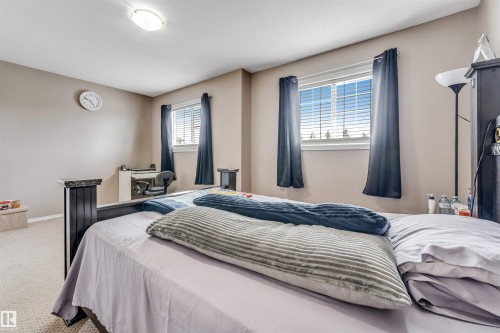 Wall-to-wall carpeting and neutral wall tones create a warm atmosphere - 135 150 Edwards Drive, Edmonton, AB - Indoor Photo Showing Bedroom