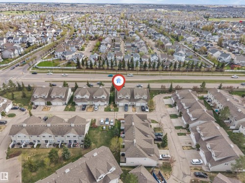 Aerial perspective showcasing a residential community with numerous single-family homes and townhomes - 135 150 Edwards Drive, Edmonton, AB - Outdoor With View