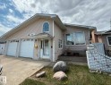 Siding exterior featuring a two-car garage, concrete driveway, and an arched window - 2812 35 Street, Edmonton, AB  - Outdoor 