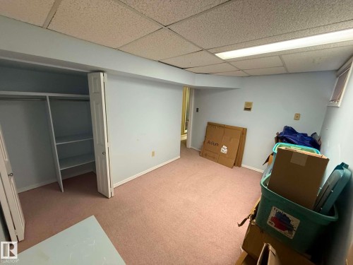 Light blue painted room with pink carpeting and a drop ceiling - 2812 35 Street, Edmonton, AB - Indoor