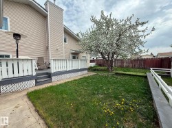 Rear exterior with a flowering tree and a wooden deck - 