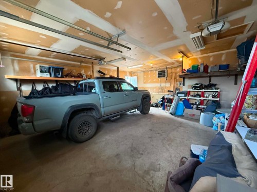 Spacious garage featuring concrete flooring and exposed ceiling beams - 2812 35 Street, Edmonton, AB - Indoor Photo Showing Garage