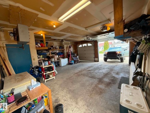 Attached two-car garage featuring a concrete floor and an automatic garage door opener - 2812 35 Street, Edmonton, AB - Indoor Photo Showing Garage