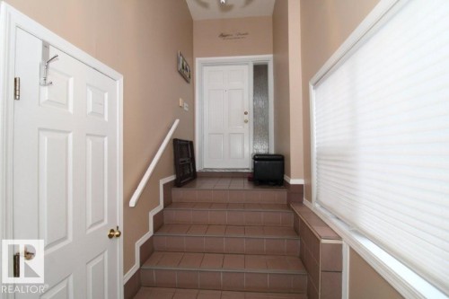 Entryway featuring light-toned walls, tile flooring, and a white paneled door with sidelight - 2812 35 Street, Edmonton, AB - Indoor Photo Showing Other Room