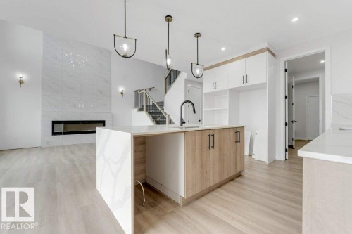 1847 Crossbill Loop, Edmonton, AB - Indoor Photo Showing Kitchen With Fireplace
