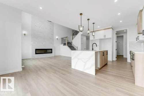 1847 Crossbill Loop, Edmonton, AB - Indoor Photo Showing Kitchen With Fireplace With Upgraded Kitchen