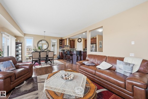 Open-concept living space featuring wood-finish flooring, recessed lighting, and a neutral wall palette - 1590 Chapman Way, Edmonton, AB 