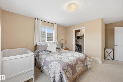 Wall-to-wall carpeting and neutral wall tones define this bedroom space - 1590 Chapman Way, Edmonton, AB 