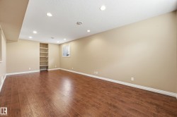 Spacious room featuring wood-finish flooring, recessed lighting, and neutral wall tones - 