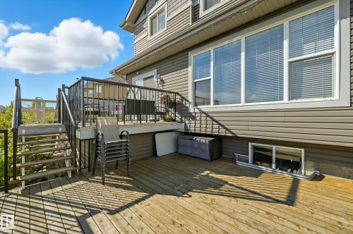 Multi-level wood deck featuring black metal railings and stairs - 1590 Chapman Way, Edmonton, AB 