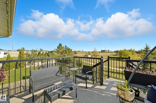 Outdoor balcony featuring concrete flooring, black metal railings, and a partially covered overhang - 1590 Chapman Way, Edmonton, AB 