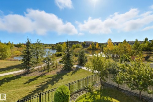 Expansive green space featuring a pond, paved walking paths, and varied tree species - 1590 Chapman Way, Edmonton, AB 
