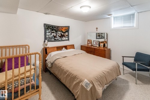 Carpeted room featuring a white ceiling, white walls, and a recessed window with blinds - 4611 Lakeshore Drive, Bonnyville Town, AB - Indoor Photo Showing Bedroom