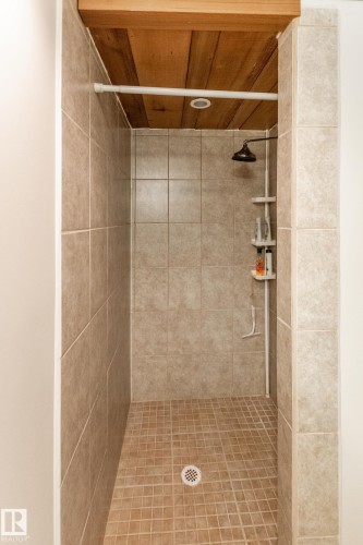 Tiled shower with a wooden plank ceiling and recessed lighting - 4611 Lakeshore Drive, Bonnyville Town, AB - Indoor Photo Showing Bathroom