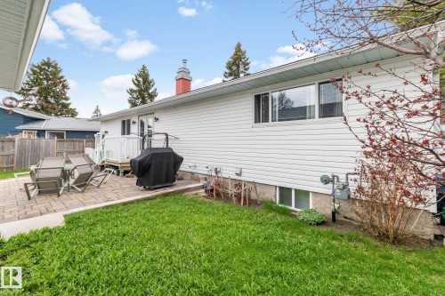 Rear exterior featuring white vinyl siding and a red brick chimney - 4611 Lakeshore Drive, Bonnyville Town, AB - Outdoor