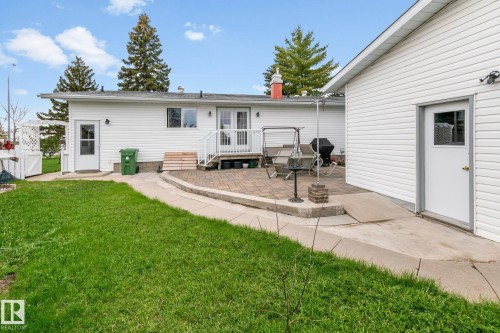 Expansive green lawn with a paver patio and white vinyl siding - 4611 Lakeshore Drive, Bonnyville Town, AB - Outdoor