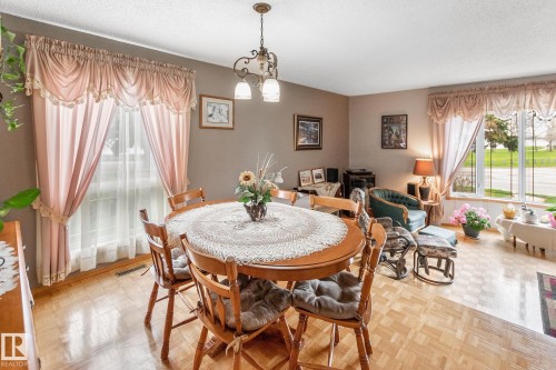 Dining area with wood-finish parquet flooring - 4611 Lakeshore Drive, Bonnyville Town, AB - Indoor Photo Showing Dining Room