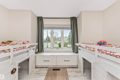 Bright room featuring a large window with privacy drapes, a built-in window seat with integrated storage drawers, and light-toned walls - 627 Forest Lane, Edmonton, AB - Indoor